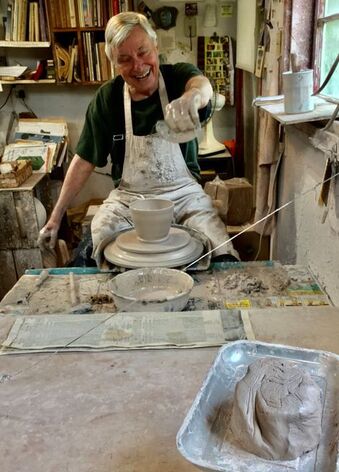 Ren Parziale enjoying the moment while using stoneware clay to throw a new piece of Sycamore Pottery